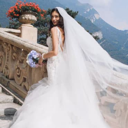 Bride holding a bouquet in a field